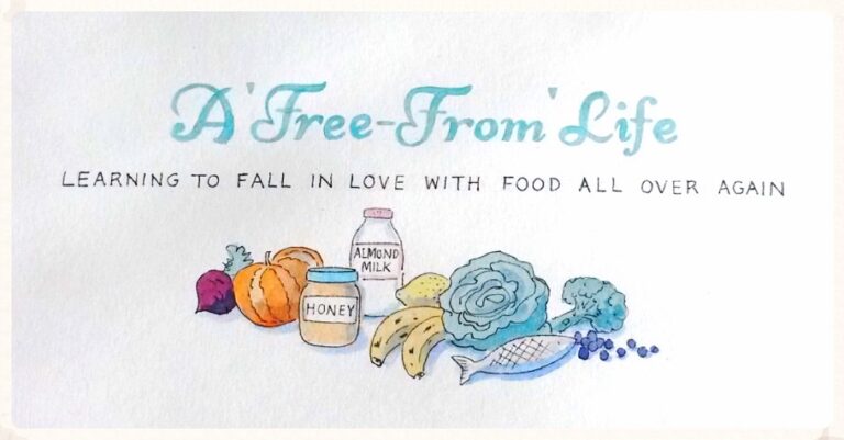 Hand-painted sign reading A Free-From Life—Learning to fall in love with food all over again, above illustrations of beetroot, pumpkin, honey jar, almond milk, bananas, broccoli, cauliflower, and fish.