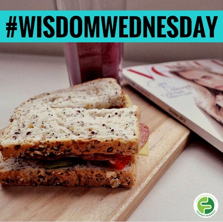 A sandwich on a wooden board sits next to a glass of juice and a fashion magazine. The text #WISDOMWEDNESDAY appears at the top in bold letters. A green circular logo is in the lower right corner.