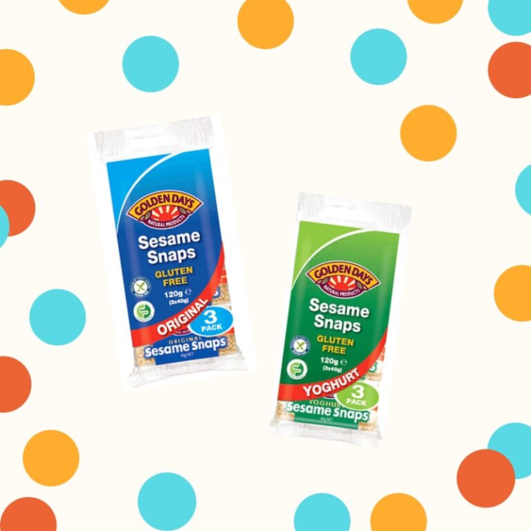 Two packets of Golden Days Sesame Snaps, one in blue (original) and one in green (yoghurt), on a background with orange, blue, and yellow polka dots. Both packets are labelled gluten free.