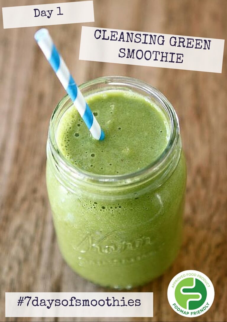 A jam jar filled with a green smoothie and a blue-striped straw sits on a wooden surface. Text on the image reads: “Day 1 CLEANSING GREEN SMOOTHIE #7daysofsmoothies” with a “FODMAP FRIENDLY” label in the corner.