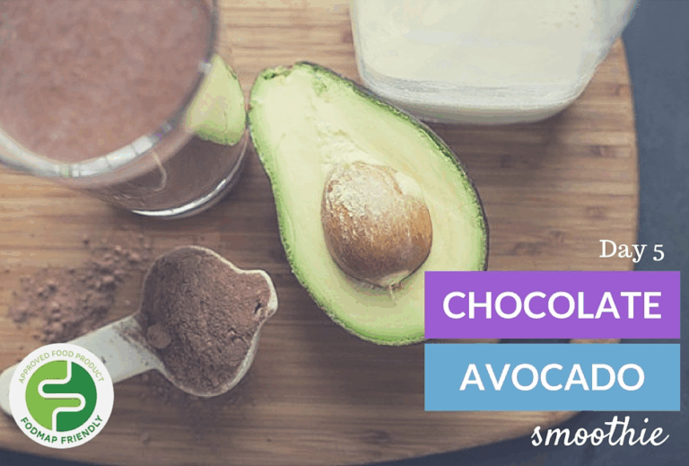 A halved avocado, a glass of chocolate smoothie, a scoop of cocoa powder, and a container of milk on a table, with text: Day 5 Chocolate Avocado Smoothie and a Fodmap Friendly label.