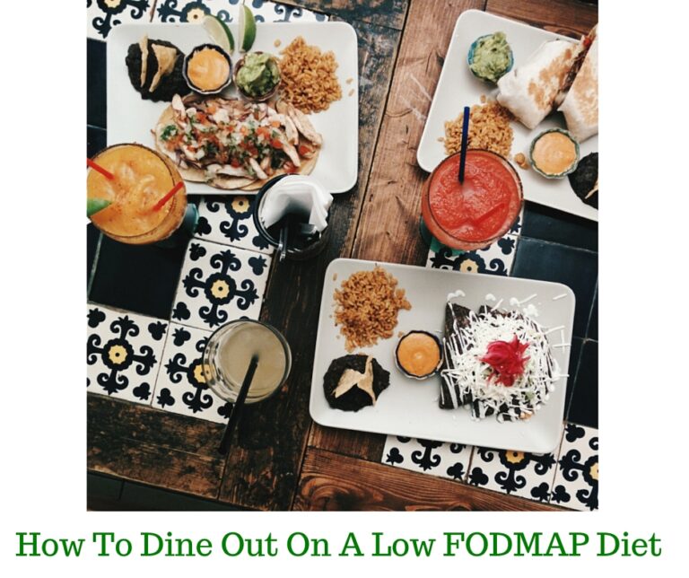 Overhead view of a restaurant table with plates of food, including rice, grilled chicken, sauces, and drinks on patterned tiles. Text at the bottom reads, How To Dine Out On A Low FODMAP Diet.