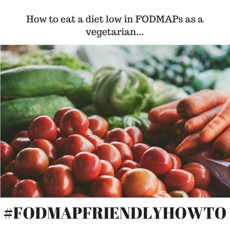 Close-up of fresh vegetables, including tomatoes, carrots, and leafy greens, displayed at a market, with text about eating a low FODMAP vegetarian diet and the hashtag #FODMAPFRIENDLYHOWTO.