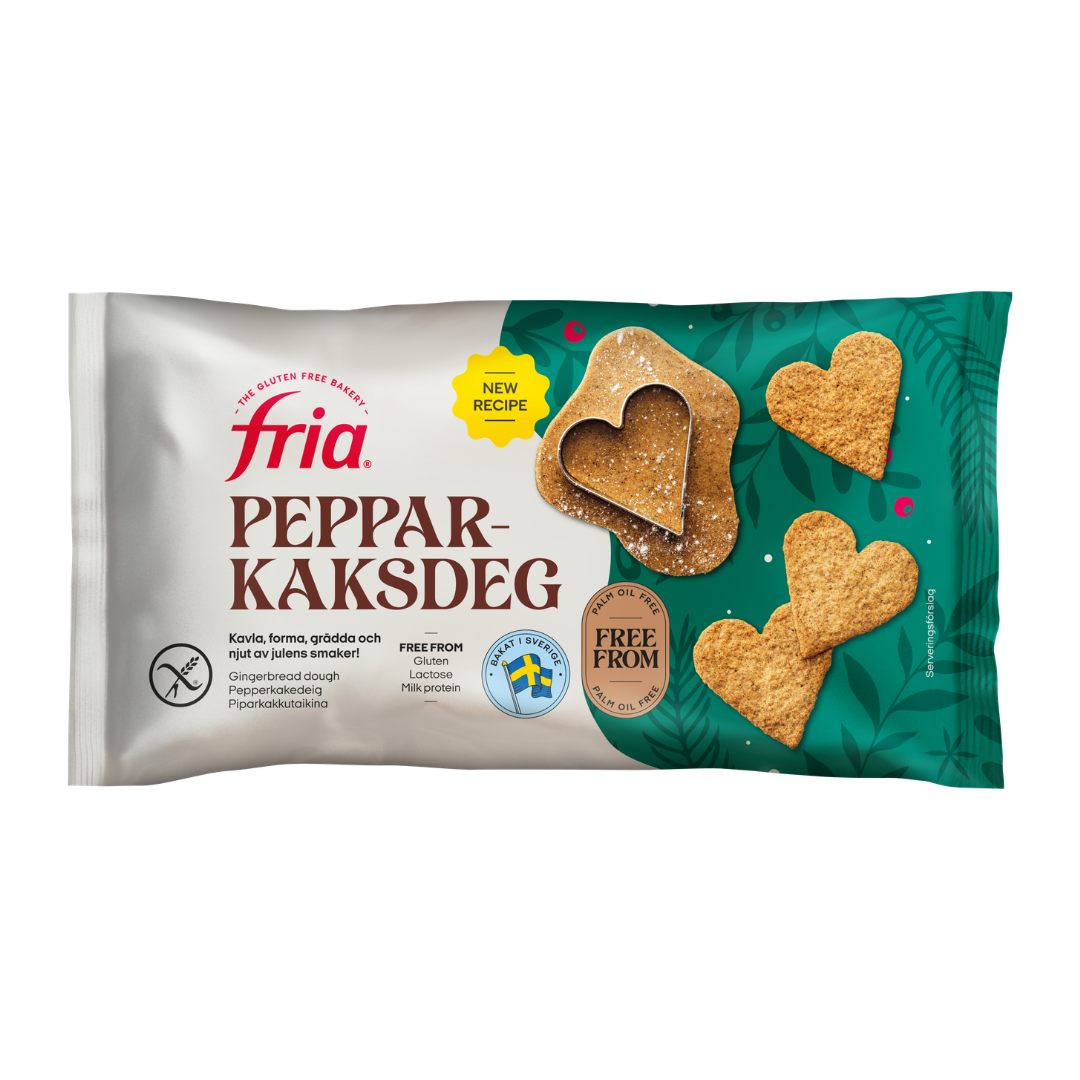 A pack of Fria Pepparkaksdeg gluten-free gingerbread dough, featuring heart-shaped biscuits and a heart-shaped cutter on a green patterned background. The pack highlights its gluten-free status and new recipe.
