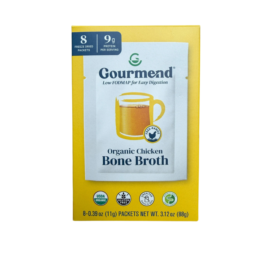 A yellow box of Gourmend organic chicken bone broth featuring a mug of broth on the front. The box highlights 8 freeze-dried sachets, 9g protein per serving, and certifications like Soil Association Organic.