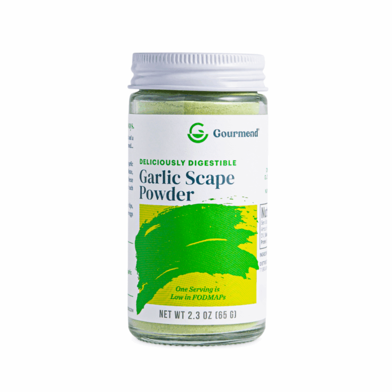 A glass jar of Gourmend Garlic Scape Powder with a white lid and green label. The label highlights that the product is deliciously digestible, low in FODMAPs, and pairs perfectly with Organic Chicken Bone Broth. Net weight: 2.3 oz (65 g).