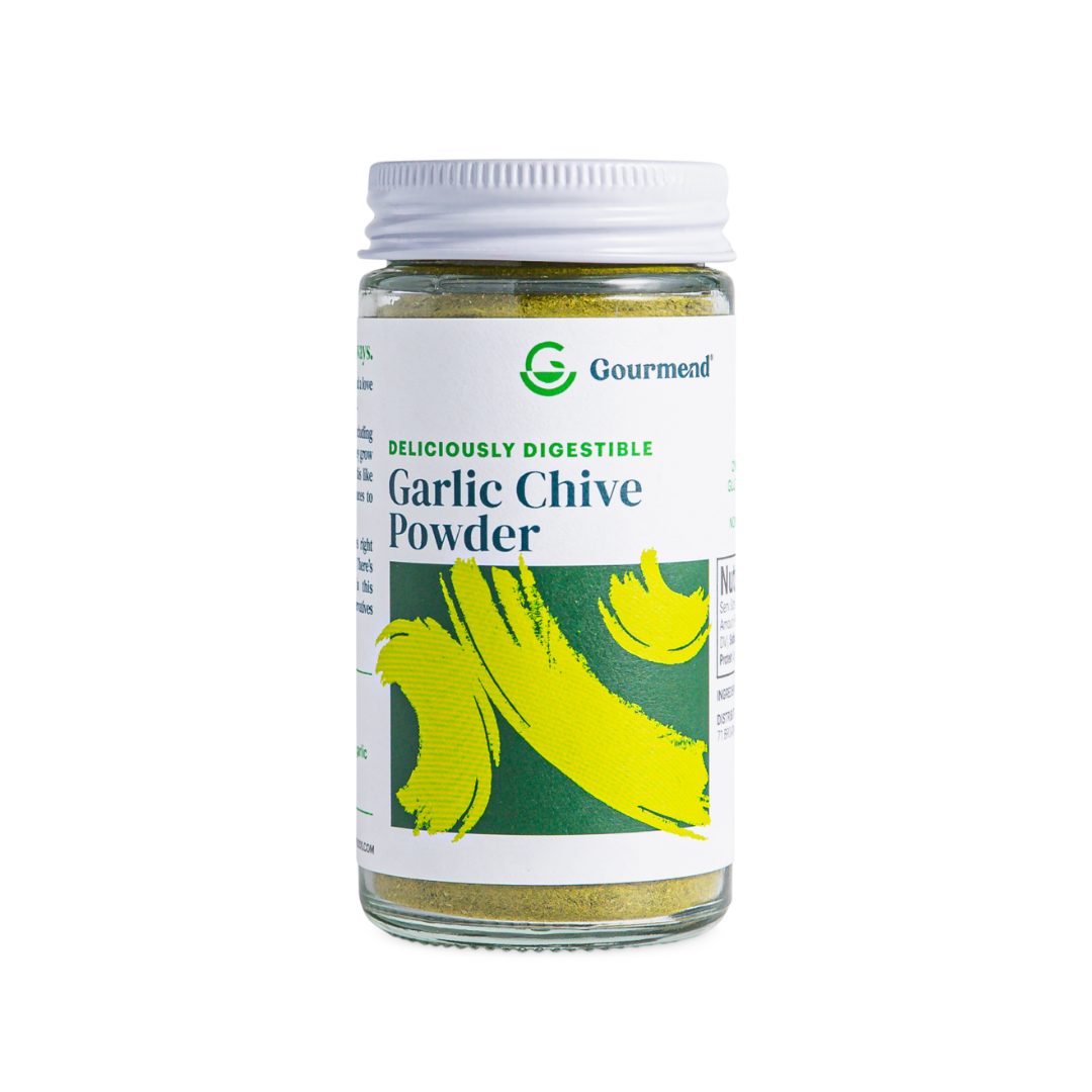 A clear glass jar with a white lid labelled Gourmend Garlic Powder featuring green and yellow brushstroke designs. The label also reads Deliciously Digestible. The jar contains a fine greenish powder, perfect for adding gourmet flavour.
