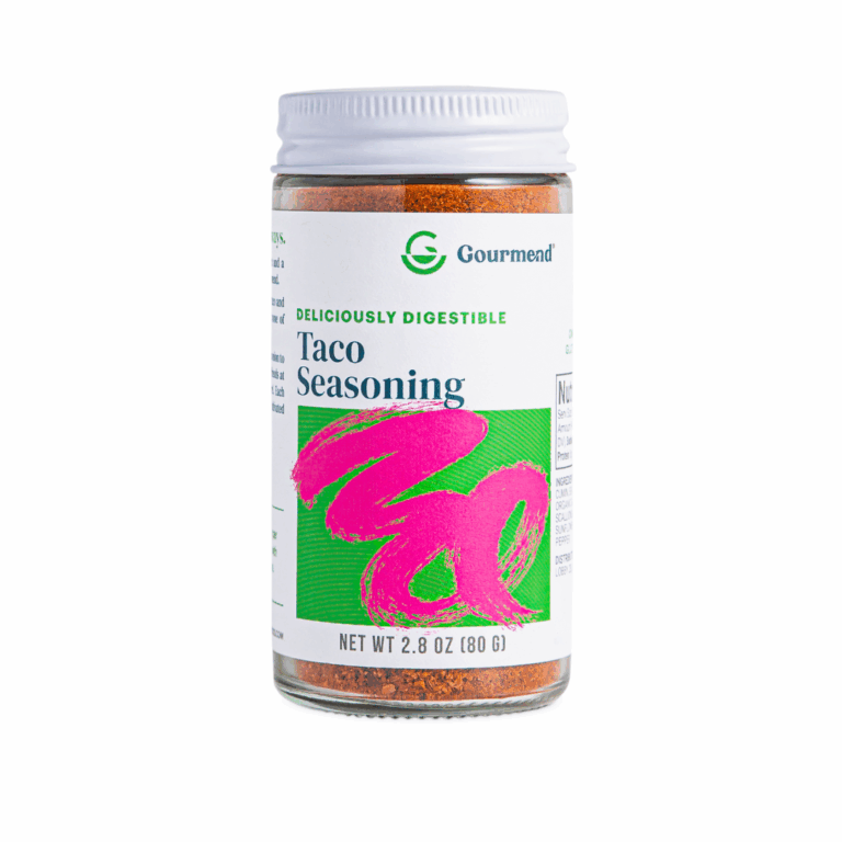 A clear spice jar labelled “Gourmend Taco Seasoning” with a white lid and a colourful label featuring green and bright pink accents. This gourmet seasoning contains 2.8 oz (80g) of flavourful Gourmend spices.