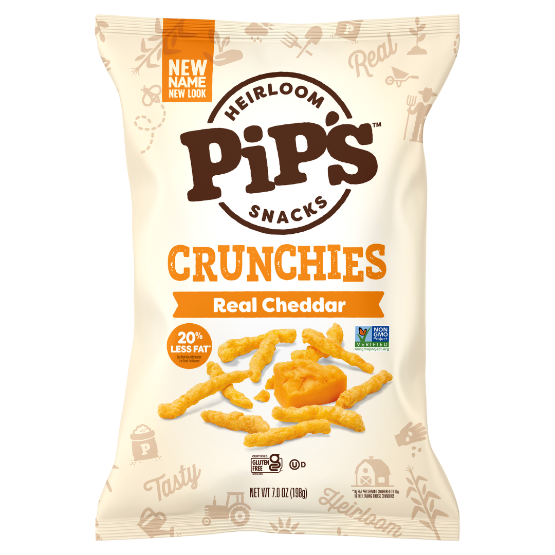 A bag of Pip’s Heirloom Snacks Crunchies in Real Cheddar flavour. The beige and orange packaging highlights the snack pieces, cheddar cheese, and labels such as “20% less fat,” “Non-GMO Project Verified,” and “Heirloom Snacks Mini Popcorn.”.