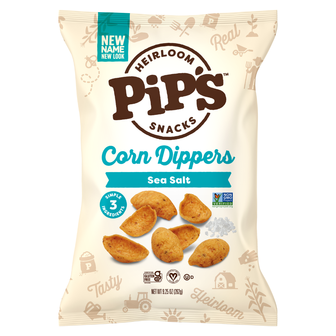 A bag of Pips Snacks Heirloom Corn Dippers in Sea Salt flavour. The beige bag, from the makers of Heirloom Snacks, features corn dippers and a small pile of salt, highlighting 3 simple ingredients and Non-GMO Project Verified labels.
