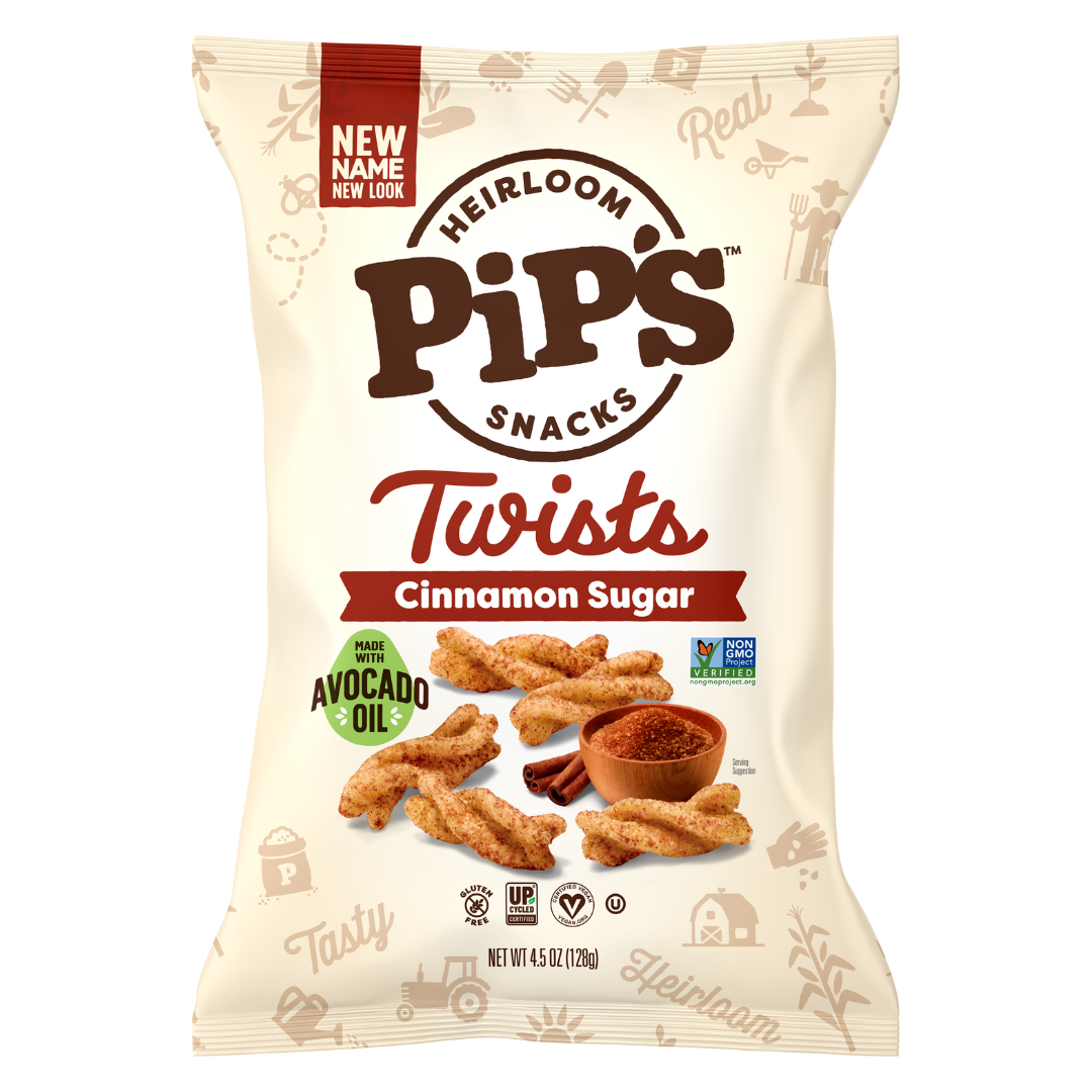 A bag of Pips Snacks Heirloom Twists in Cinnamon Sugar flavour. The cream-coloured bag showcases crispy twists, a bowl of cinnamon sugar, and highlights “Made with Avocado Oil” and “Non-GMO Project Verified”—delicious heirloom snacks!.
