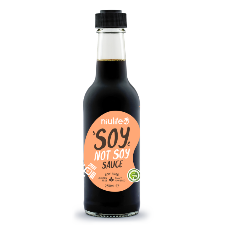 A clear glass bottle with a black cap contains Niulife Soy-Not-Soy Sauce, a soy sauce alternative. The label notes it is soy free, gluten free, and made from plant-based ingredients.